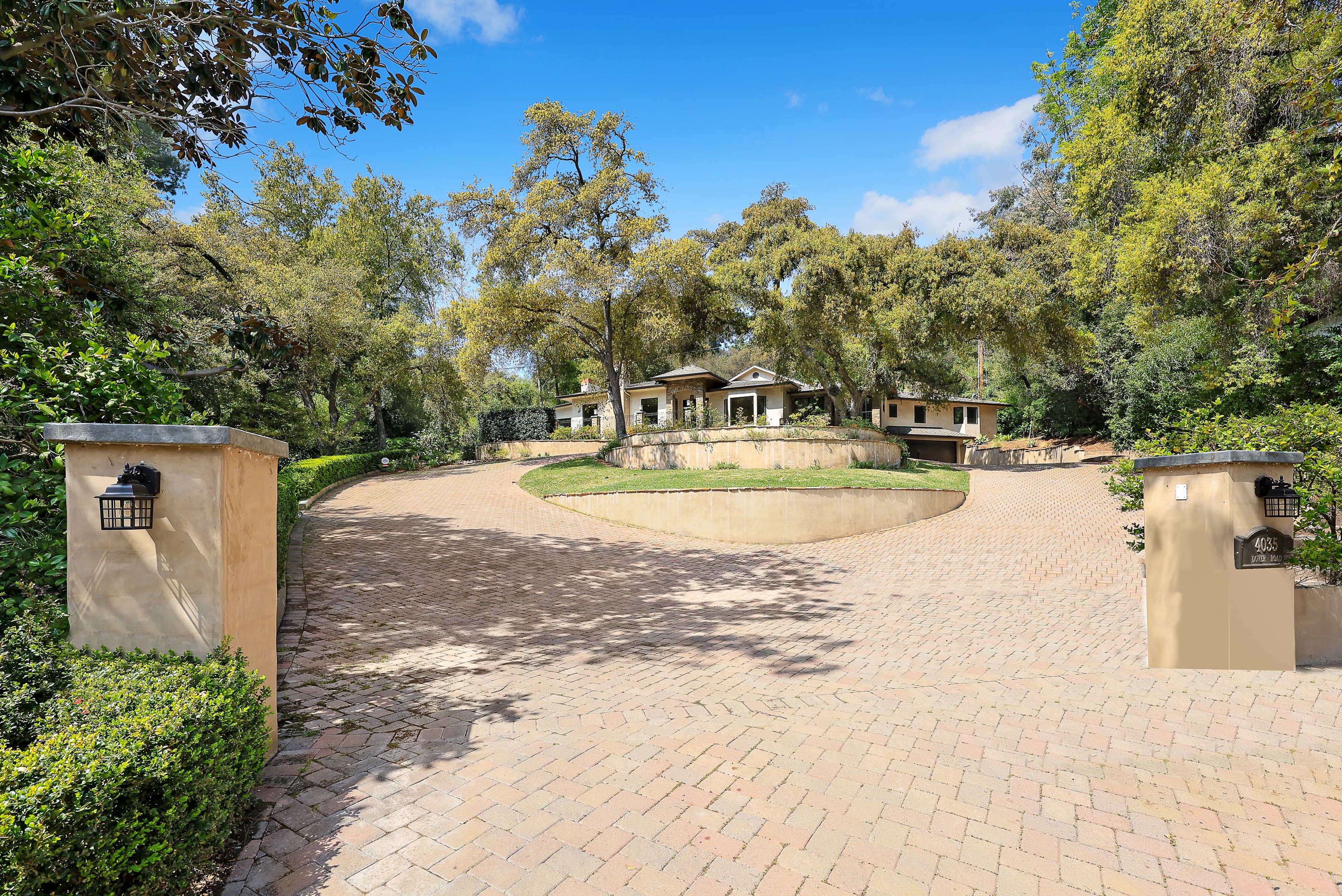 Gated estate entrance with circular brick drive